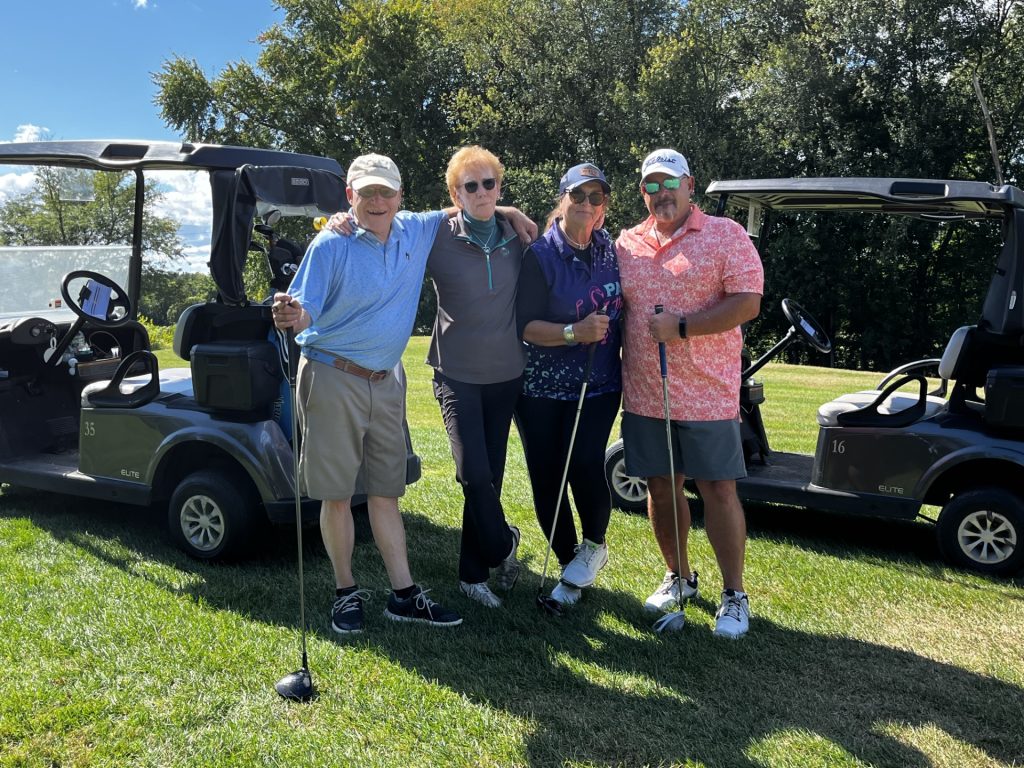 Golfers hanging out on the green